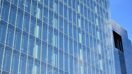 Facade texture of a glass mirrored office building. Fragment of the facade. Modern architecture of the office building.