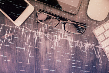 Multi exposure of forex graph hologram over desktop with phone. Top view. Mobile trade platform...