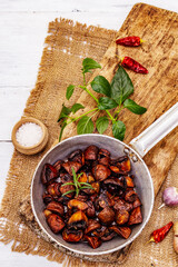 Ready to eat hot fried brown champignons in vintage pan