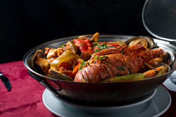 Seafood cataplana, typical Portuguese dish, with lobster, shrimps, mussels, vegetables.