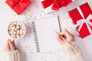 Top above overhead close up view photo of female hands making notes on blank paper letter enjoy...