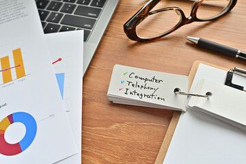 There is a piece of paper with a graph printed on it, a clipboard, and an open vocabulary book on...