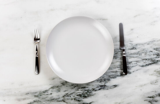 Table Set For Dinner With Clean Plate And Utensils