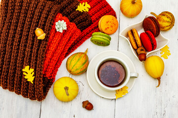 French macarons in autumn colors with cup of hot tea