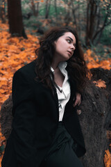 Girl in a jacket and shirt in the autumn forest