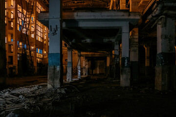 Fototapeta na wymiar Dark creepy empty abandoned industrial building interior at night