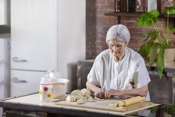 Senior woman preparing pastries in the kitchen at home
