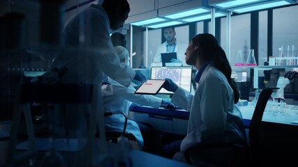 Medical Research Laboratory Meeting: Diverse Team of Scientists Use Digital Tablet Computer, Discuss Innovative Biotechnology. Advanced Lab for Medicine, Technology Development. Blue Evening Shot
