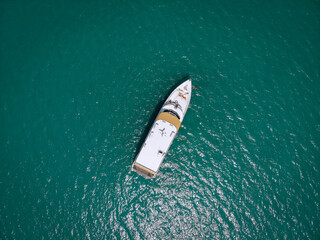 Aerial picture of an isolated yacht with brown wooden design in the sea. Andaman sea