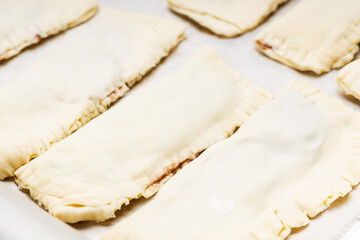 uncooked sweet pastry bun at a cooking tray. homemade cooking concept