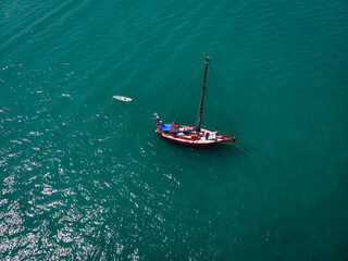 Aerial view of a  sailing yacht in the turquoise water of the Andaman sea. Phuket. Thailand