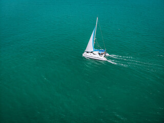 Aerial view of a  sailing yacht in the turquoise water of the Andaman sea. Phuket. Thailand