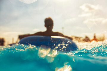 Cool people having fun on the water slide with friends and familiy in the aqua fun park glides...