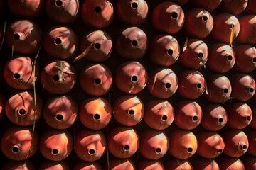 The surface of the wall resembles a circular ceramic with several holes in the center.