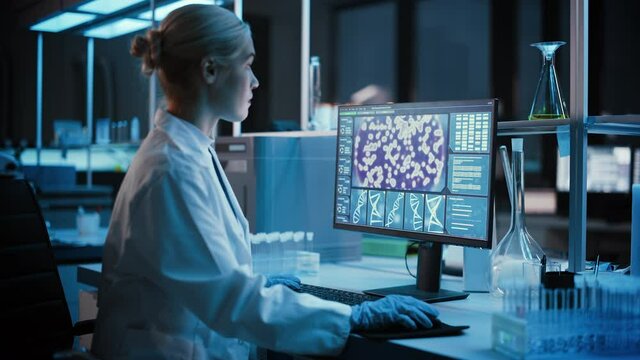 Medical Research Laboratory: Portrait of Female Scientist Working on Computer, Analyzing DNA, Virus