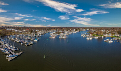 Fototapeta premium Scenic aerial panorama of Deale waterfront fishing village on the Western Shore of Chesapeake Bay Maryland, popular with boaters. Four tidal creeks Rockhold, Broadwater, Carrs , Parker flow into bay