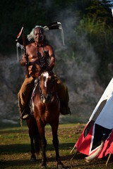 Portrait of the person riding a horse and feathered headdress with weapon