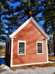 Red schoolhouse in Sudbury, Massachusetts in wintertime