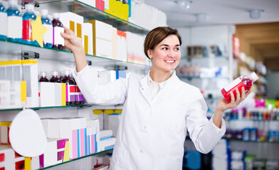 Adult girl is browsing rows of body care products in pharmacy.