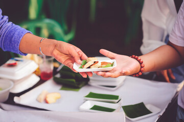 The hand of a beggar receives food from the donor: Donate food to hungry people