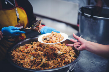 Volunteers Share Food to the Poor: concept of poverty in Asian society