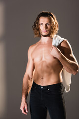 Naklejka premium shirtless man with long hair posing on dark background