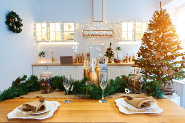 Gala dinner. Cooking at Christmas. New year's interior in the kitchen. Decorations: Christmas tree, garland, cones and glasses, gold and green
