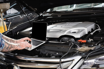 partial of repairman making diagnostic of car engine compartment