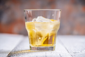 Whiskey on the rocks with winter christmas decorations. Selective focus. Shallow depth of field.