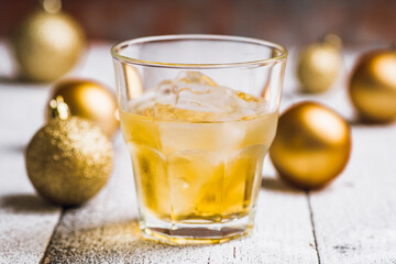 Whiskey on the rocks with winter christmas decorations. Selective focus. Shallow depth of field.