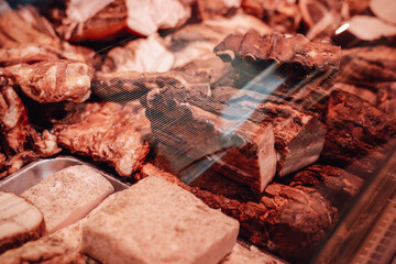 Counter of modern meat shop full filled and neatly folded with quality and fresh smoked meat.