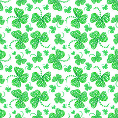 Seamless pattern of three-leaf clovers from green hearts isolated on a white background. Symbol of good luck and wealth. Design for greeting cards, holiday wrapping paper, fabric.