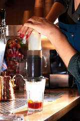 Barista pushing coffee in an aeropress. Alternative method.