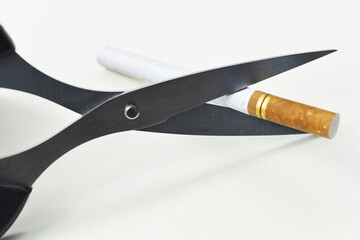 Quit smoking concept with scissor cutting cigarette 
