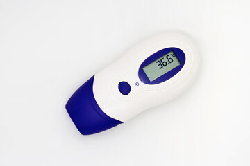 A non-contact infrared thermometer on white background showing temperature 36.6