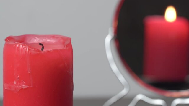 Concept video of a lighted candle that is not reflected in the mirror.Christmas divination and spirituality.Religion and divine.Psychology,motivation.Power of thought.Never give up,go for your goals.
