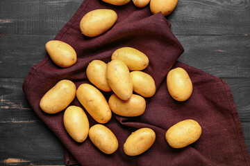 Raw potatoes on wooden table