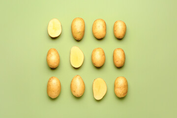 Raw potatoes on color background
