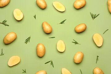 Raw potatoes on color background