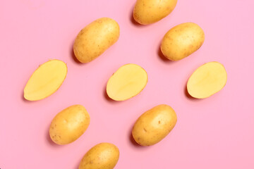 Raw potatoes on color background
