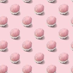 Seamless pattern of two-tone white and pink marshmallows on a pink background.