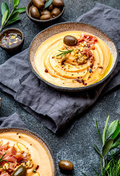Spanish tomato cold soup Salmorejo served with ham serrano and olives