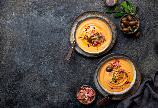 Spanish tomato cold soup Salmorejo served with ham serrano and olives