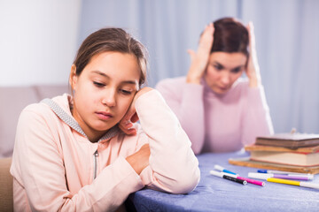 Fototapeta premium Mother talking seriously with her teenage daughter about poor school performance