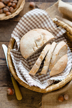 A small loaf of homemade bread in a bread basket