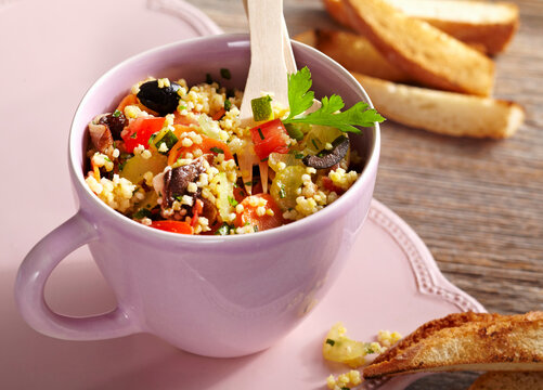 Vegan millet salad with vegetables and toasted bread
