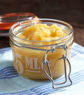 Apple and orange sauce with horseradish and vinegar in a flip-top jar