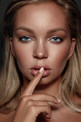 Naklejka premium Close-up portrait of a beautiful woman with blue eyes . Strong skin texture. Natural makeup, clean healthy skin. Eyebrows. Eyes. Puffy lips.