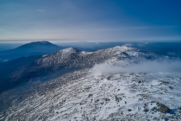 Obraz premium Snow-capped mountains in clouds Beautiful mountain peaks