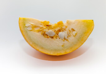 A piece of pumpkin close-up on a white background. Focus in the center